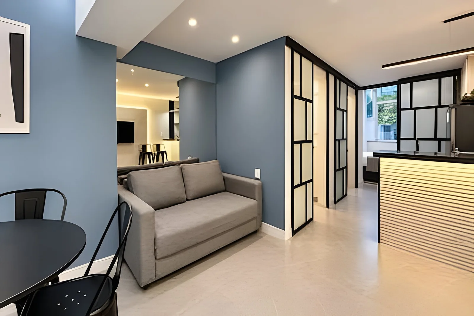 Short-term rental apartment with a sofa, dining table and open-plan kitchen