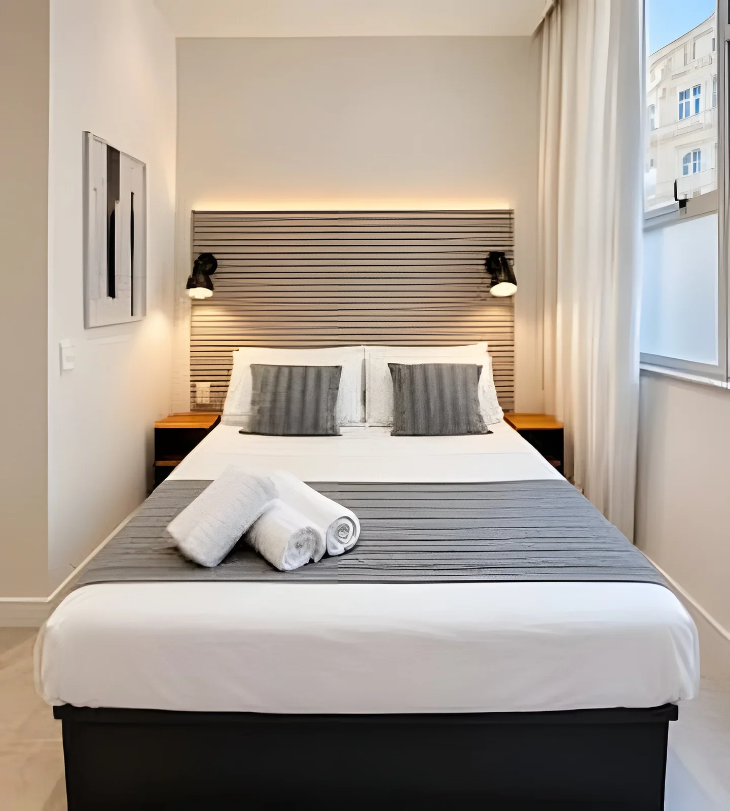 Carefully prepared bed with white linen and towels for the next guests